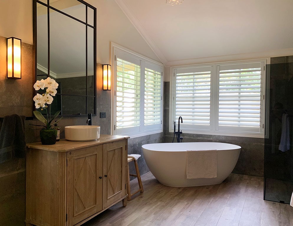 White bathroom shutters for a peaceful room